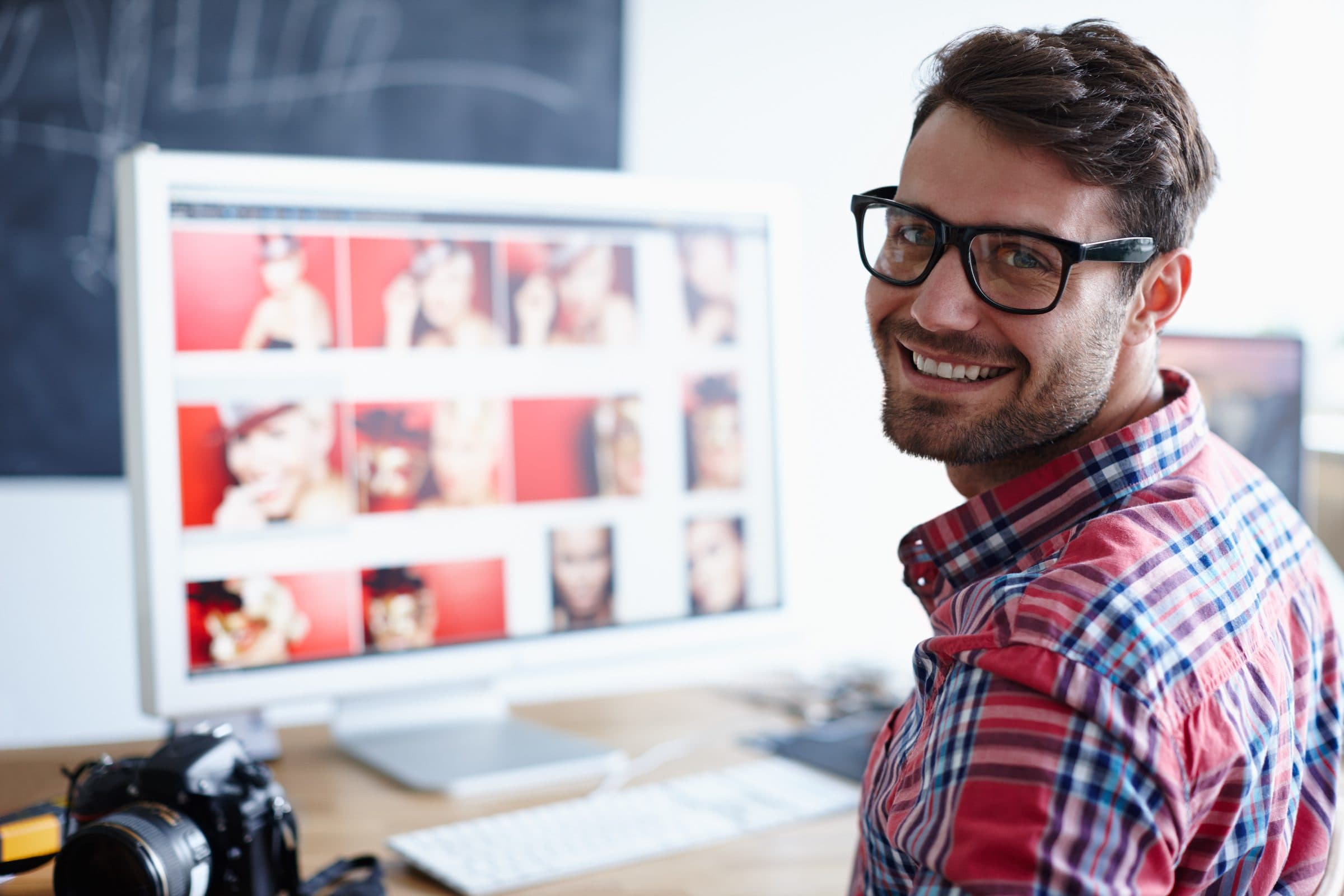 A creative professional reviewing photos at his desk